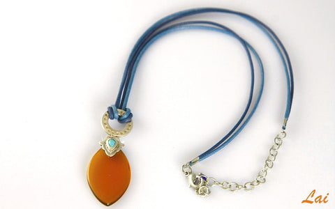 Artistic, navette shape amber colour glass pendant on contrasting blue cord - Lai