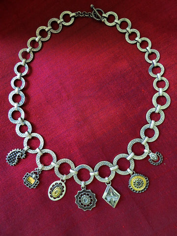 Conversation-starting, mehndi-inspired charms necklace with gold and black rhodium plated detailing