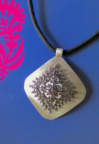 Gorgeous, kite-shaped pendant with mehndi-inspired black rhodium plated center unit