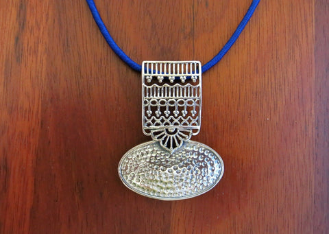 Graceful and artistic, Kutch-inspired, long pendant with hammer finish and intricate jali work