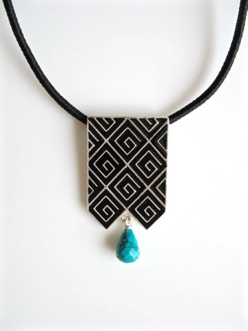 Stunning, long rectangular pendant with fine black enamel work and a turquoise drop