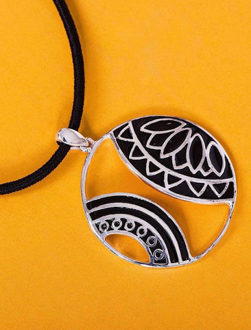 Artistic round pendant with cut outs and fine black enamel detailing - Lai