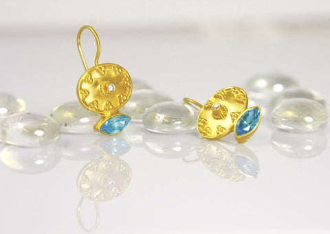 Ethereal, gold-plated oval earrings with navette shape blue topaz