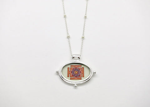 Exquisite, oval Lotus Yantra pendant on a floating pearl chain
