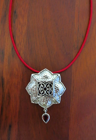 Gorgeous, Kutchi, 8 petal floral hammer finish pendant with jali work & a garnet drop - Lai