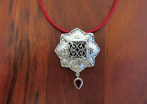 Gorgeous, Kutchi, 8 petal floral hammer finish pendant with jali work & a garnet drop