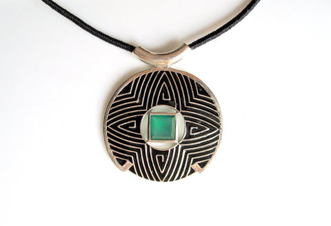 Gorgeous, large round pendant with fine black enamel work and a faceted chrysoprase