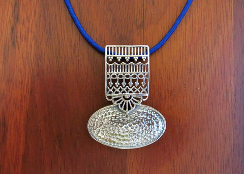 Graceful and artistic, Kutch-inspired, long pendant with hammer finish and intricate jali work - Lai