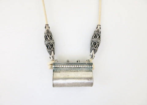 Handsome and super versatile, cylindrical amulet necklace