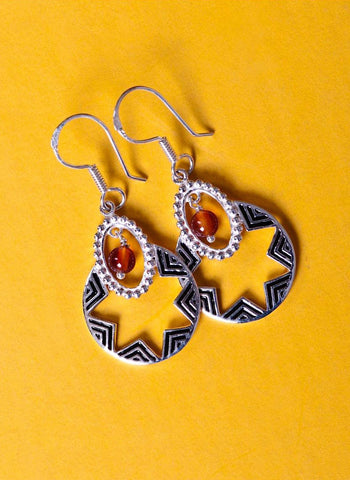 Quaint, oval dangling earrings with a garnet bead and fine black enamel work - Lai
