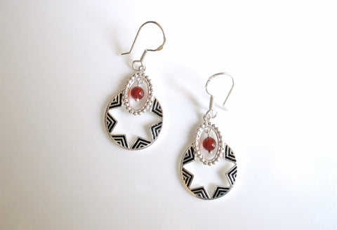 Quaint, oval dangling earrings with a garnet bead and fine black enamel work - Lai