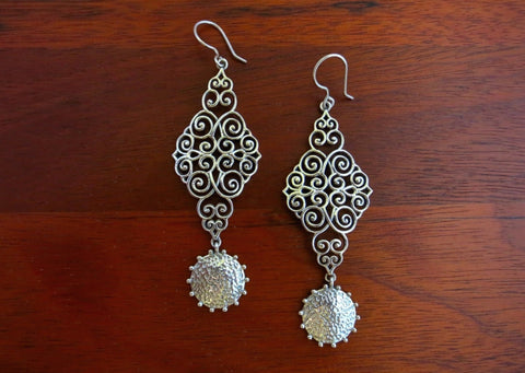 Stunning, wire scroll-pattern earrings with a dangling hammered disc