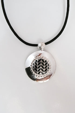 Super chic, round pendant with fine black enamel work center - Lai