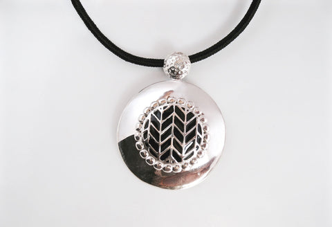 Super chic, round pendant with fine black enamel work center - Lai